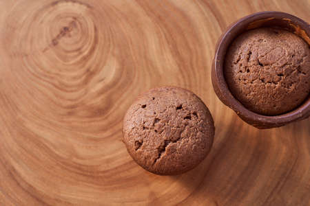 Homemade chocolate cupcakes on a wooden table. High quality photo