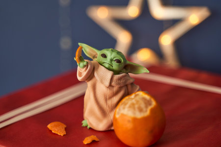 Dec, 2020: Display of Baby Yoda, an action figures, standing on christmas background. Bokeh effect.のeditorial素材