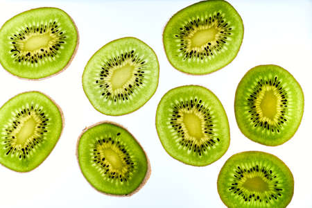Close up photo of kiwi on white background. Kiwi fruit cut in half with seeds inside, macro view.の写真素材