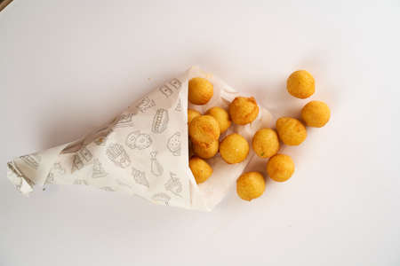 Potato balls in a paper bowl on a white background. High quality photoの写真素材