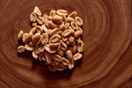 Salted peanuts on a wooden background. High quality photoの写真素材