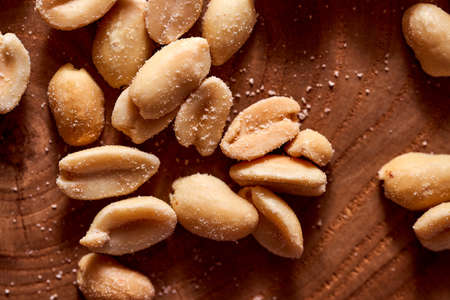 Salted peanuts on a wooden background. High quality photoの写真素材