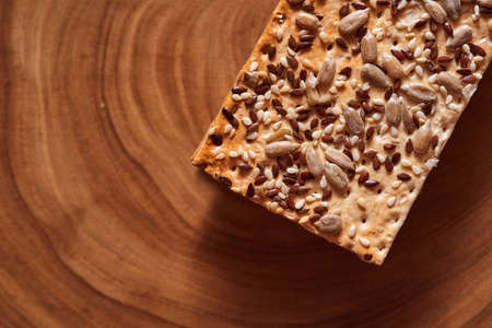 Flour breadcrumbs biscuits with sunflower flax seeds on awooden background. Top view. High quality photoの写真素材