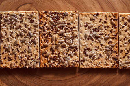 Flour breadcrumbs biscuits with sunflower flax seeds on awooden background. Top view. High quality photoの写真素材