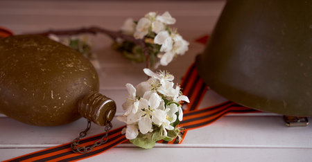 branches with white apple blossoms in an iron teapot on a brown background. high quality photoの写真素材