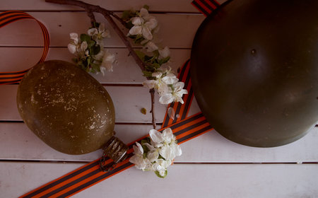 branches with white apple blossoms in an iron teapot on a brown background. high quality photoの写真素材