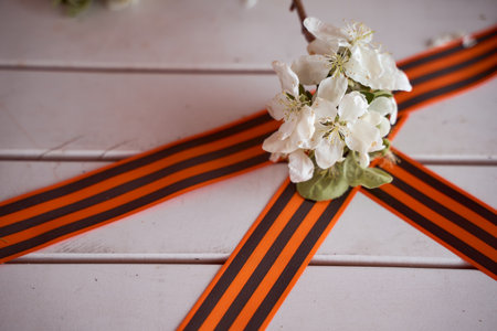Black orange St. George ribbons on a wooden background. high quality photoの写真素材