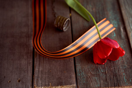 Black orange St. George ribbons on a wooden background. high quality photoの写真素材