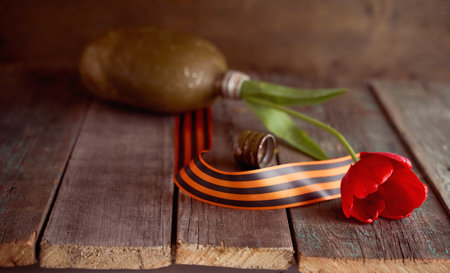 Red tulip in a soldier's military flask with St. George ribbons. high quality photoの写真素材