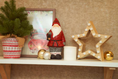 Christmas decorations. Wooden star and santa claus figurine and decorative fir tree in a potの写真素材