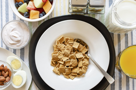 A bowl of cereal as part of a balanced breakfast.  Includes:  Yogurt, almonds, hard boiled egg,...