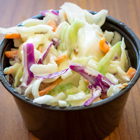 Top side view of a small black portion sized container of a creamy coleslaw.の写真素材