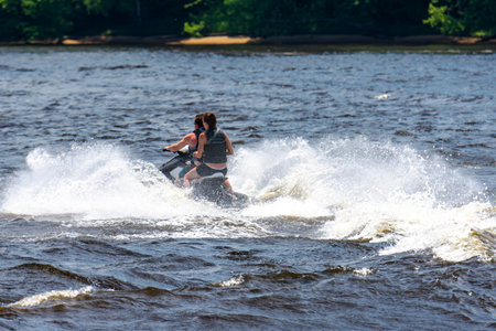 A man and a woman ride tandem on a jet ski on the Wisconsin River near Wisconsin Dells.の写真素材