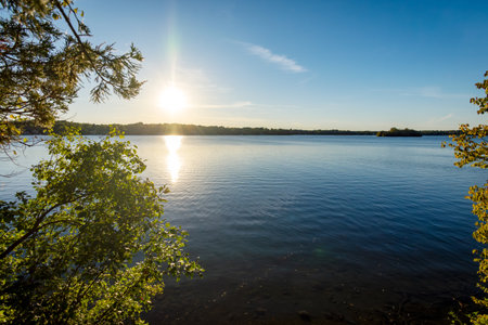 Sun in the late afternoon on a Wisconsin lake in early October.の写真素材