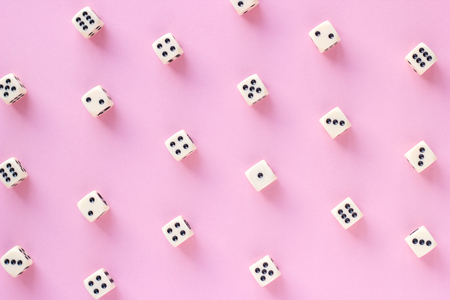 Gaming dice pattern on pink background in flat lay style. Concept for games, game board, presentation, banners or web. Top view. Close-up.の写真素材