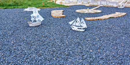Models of sailing ships sail on the sea from rubble.の写真素材