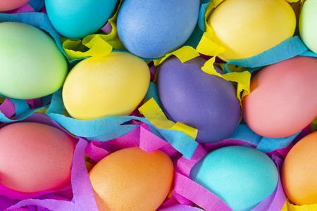 Easter colorful dyed chicken eggs with colorful ribbons.の写真素材