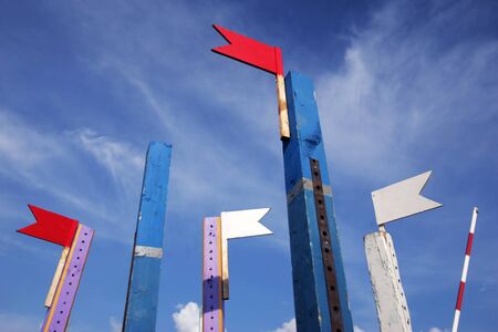 Wooden show jumping barriers with flags on the blue sky background. Colorful barriers for equestrian obstacles.の写真素材