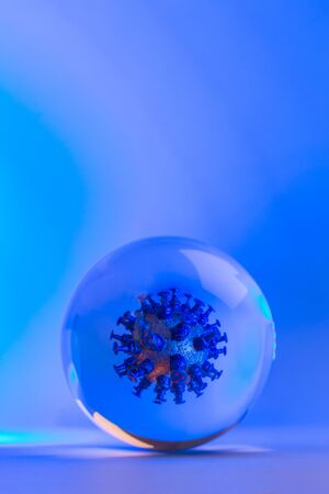 Virus of COVID-19 inside the cell. Mockup of virus in a glass sphere, coronavirus vertical abstract concept on blue background.の写真素材