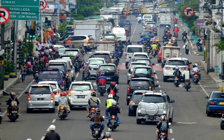 Busy hour in Asia Afrika Street, in Bandung, Indonesia. With many motorcycles and cars in the roadのeditorial素材