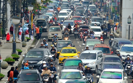 Busy hour in Asia Afrika Street, in Bandung, Indonesia. With many motorcycles and cars in the roadのeditorial素材