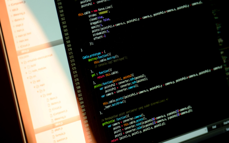 Programmer screen at work, showing lines of javascript programming language code in black text...