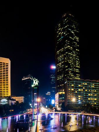 Selamat Datang monument in front of Jakarta's skyscrapers. Captured in Bundaran Hotel Indonesia, or Hotel Indonesia roundabout, Sudirman Street,  Jakarta.  Urban Skyline, Building Exterior, Capital Citiesのeditorial素材
