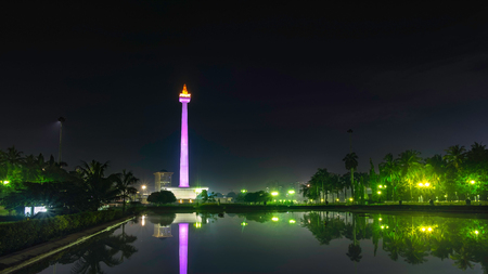 National Monument (Monas) at night, in front of big pool, create beautiful reflection of this monument., this is one of iconic monument in Jakarta, Indonesiaのeditorial素材
