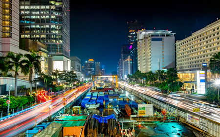 Monorail or mass rapid transit construction at night, in M.H Thamrin Street, Jakarta. Showing beautiful buildings and light trail from busy traffic.  Urban Skyline, Building Exterior, Capital Citiesのeditorial素材