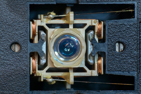 This is  close photo of laser head in optical drive, showing its lens and copper coil to control the head movement when read data from the diskの写真素材