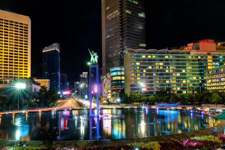 Selamat Datang monument in front of Jakarta's skyscrapers. In the center of bundaran Hotel Indonesia, or Hotel Indonesia roundabout, Sudirman Street,  Jakarta. Urban Skyline, Building Exterior, Capital Citiesのeditorial素材