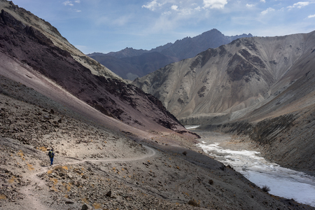 A man treks along the frozen river in Markha valley trekking route, Leh Ladakh, Indiaの写真素材