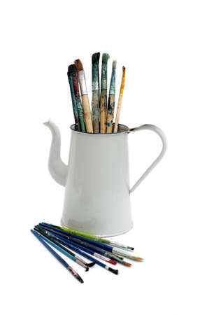 Paint Brushes used in vintage jug isolated on white backgroundの写真素材