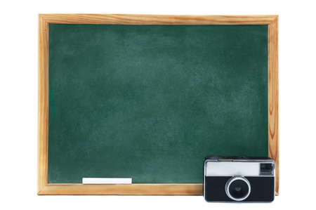 Blackboard with vintage photographic camera isolated on white backgroundの写真素材