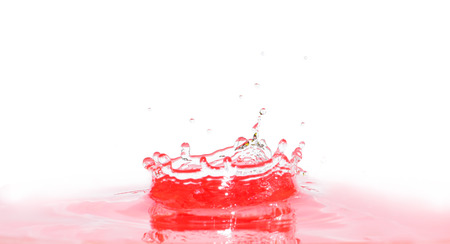 Water drop or bubble falling into water surface and making a crown. Splash background.の写真素材