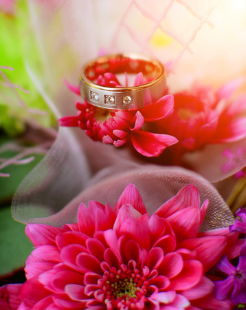 Detail of wedding rind on beautiful flowers. Wedding day background theme.の写真素材