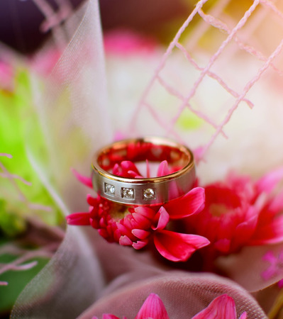 Detail of wedding rind on beautiful flowers. Wedding day background theme.の写真素材
