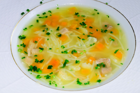 Fresh hot soup with vegetable and homemade noodles. Food background.の写真素材