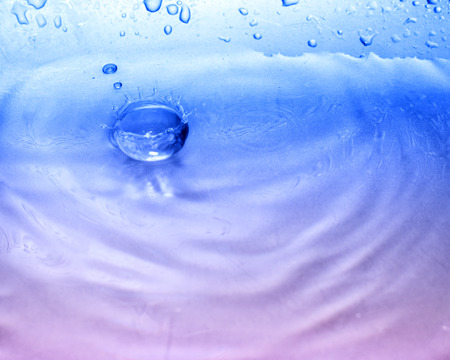detail of water drop falling into water surface. Beautiful nature.の写真素材