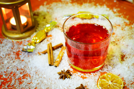 Winter hot drink punch with few ingredients - cinnamon, badyan, fruit. Snow christmas holiday backround.の写真素材