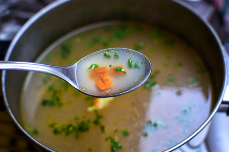 Detail of a spoon with vegetable vegetarian soup. Food.の写真素材