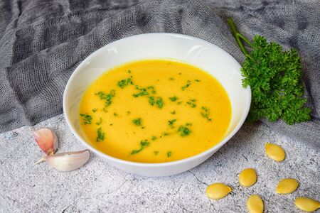 Vegetarian autumn pumpkin cream soup with seedsの写真素材