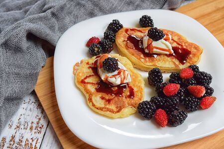 pancakes with fresh blueberries and honey for breakfast, top view, horizontalの写真素材