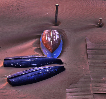 Boats upside down in the sand of the beachの写真素材