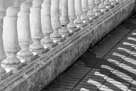 Detail of lights and shadows projected by the sun in a balustradeの写真素材