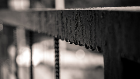 Detail in perspective of water drops on a fenceの写真素材