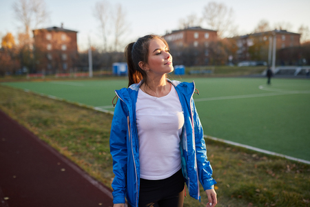 Young athletic girl trains at the stadium.の写真素材