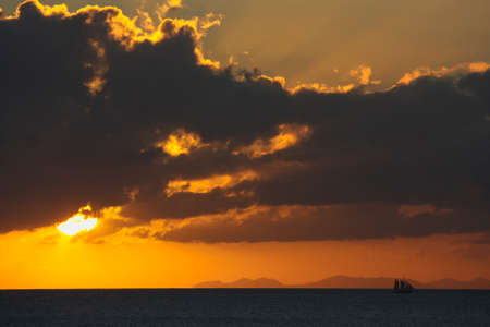 Sea sunset with some cloudsの写真素材