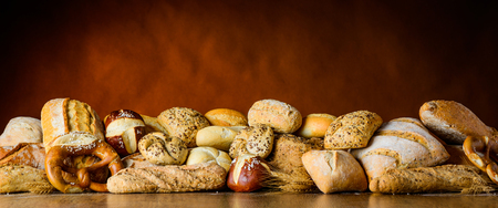 a pile of bun and bread on a wooden table in traditional still-lifeの写真素材