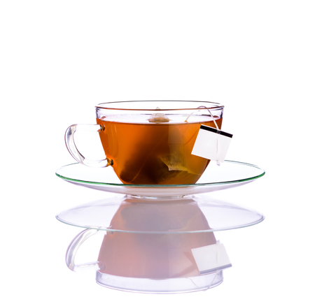One cup of fruit Tea with tea-bag isolated on white background and with reflectionの写真素材